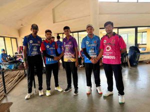 T20 ICL cricket squad in blue jerseys posing together on the beach during state selection camps and tournament tours.